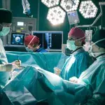 Dr. Philipp Brentano (Thomas Koch, li.) fragt Prof. Maria Weber (Annett Renneberg, 2.v.re.), ob sie sich tatsächlich imstande fühlt Kai Hoffmann zu operieren. Sie weiß, worauf Philipp hinaus will, doch auch er ist sein bester Freund. Es gibt also keinen Unterschied. Noch dazu offenbart Maria, dass Kai sie in seine Patientenverfügung geschrieben hat. hi.mi: Dr. Kathrin Globisch (Andrea Kathrin Loewig), re: OP-Schwester (Komparsin)